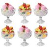 Six clear glass dessert bowls with faceted pedestal bases, arranged in a 2x3 grid on a white background. Each bowl is filled with pink ice cream or gelato and topped with strawberries, grapes, and fruit pieces.